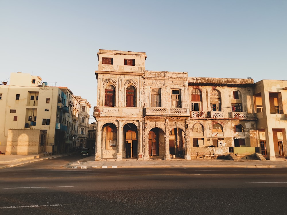 an old run down building in the middle of a street