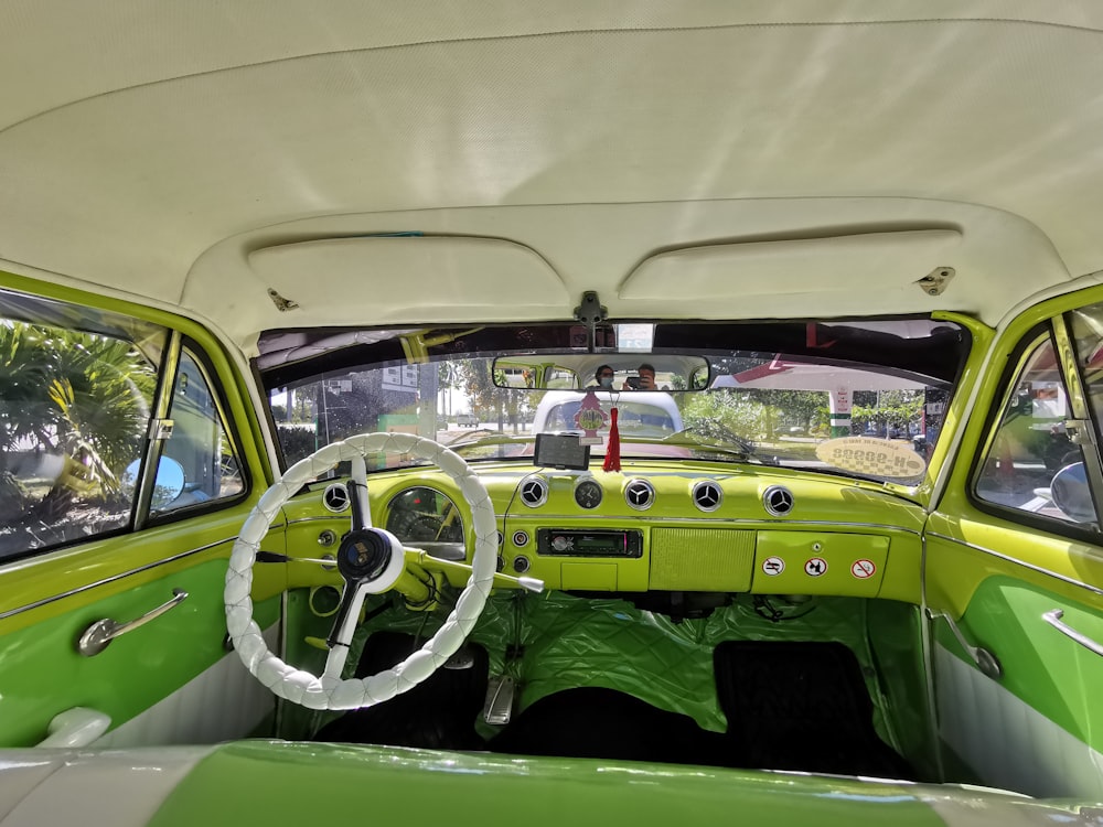 a green and white car with a steering wheel