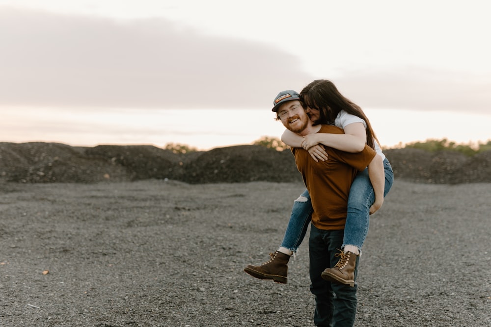 a man carrying a woman on his back