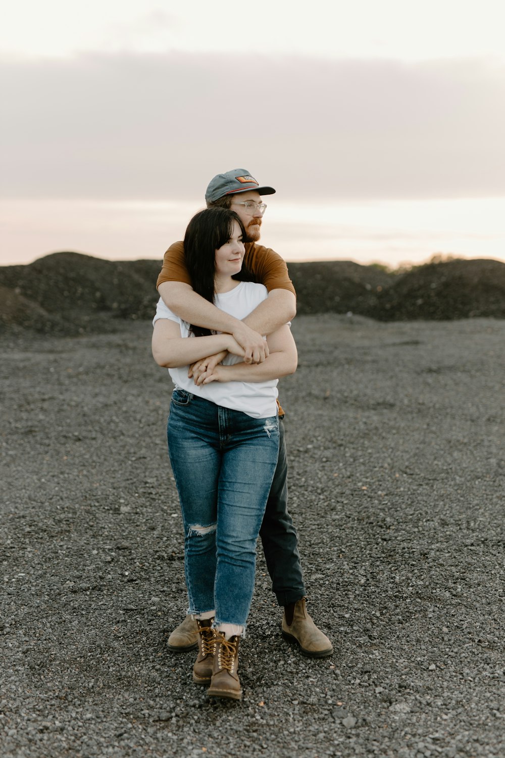 a man and a woman hugging in a field