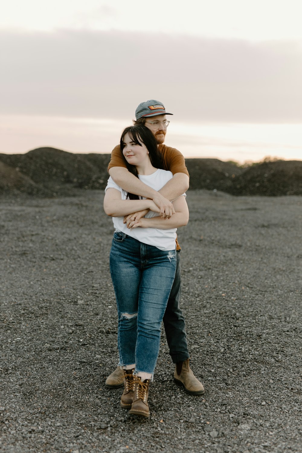 a man hugging a woman in the middle of a field