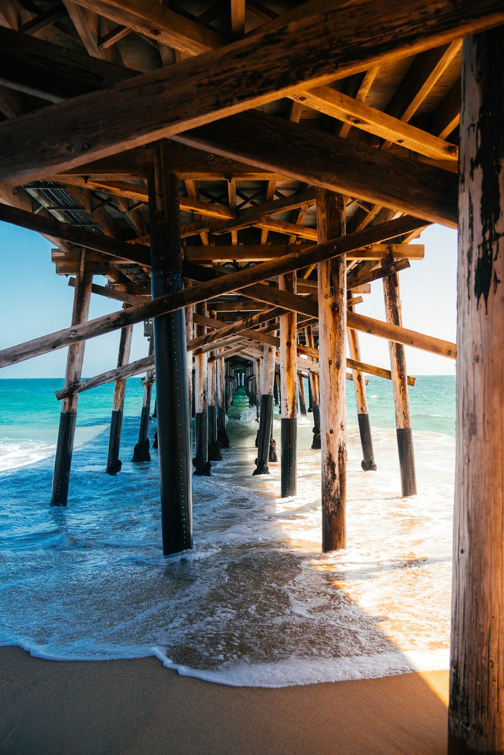 a pier with waves coming in and out of the water