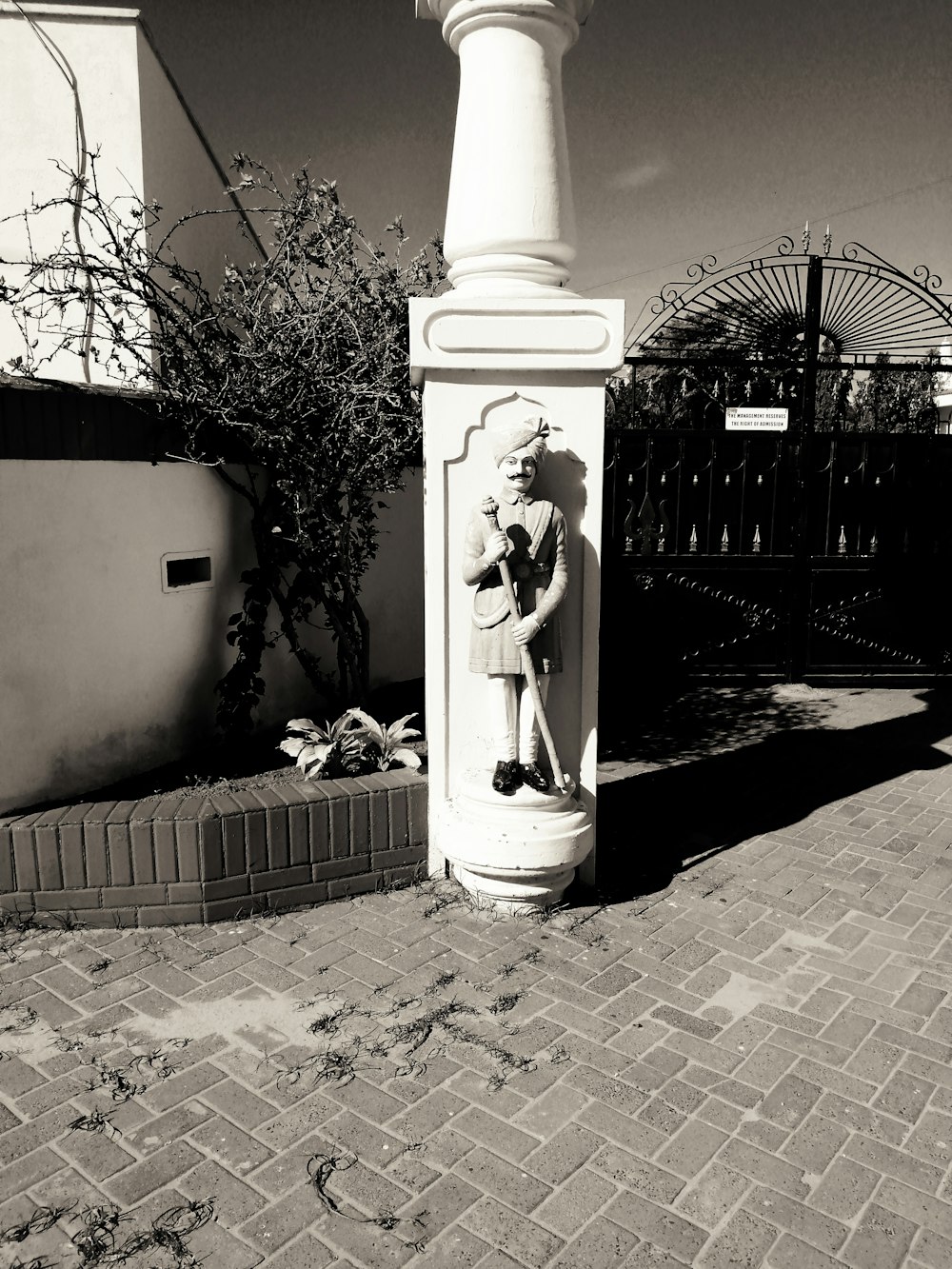 a black and white photo of a statue of a woman