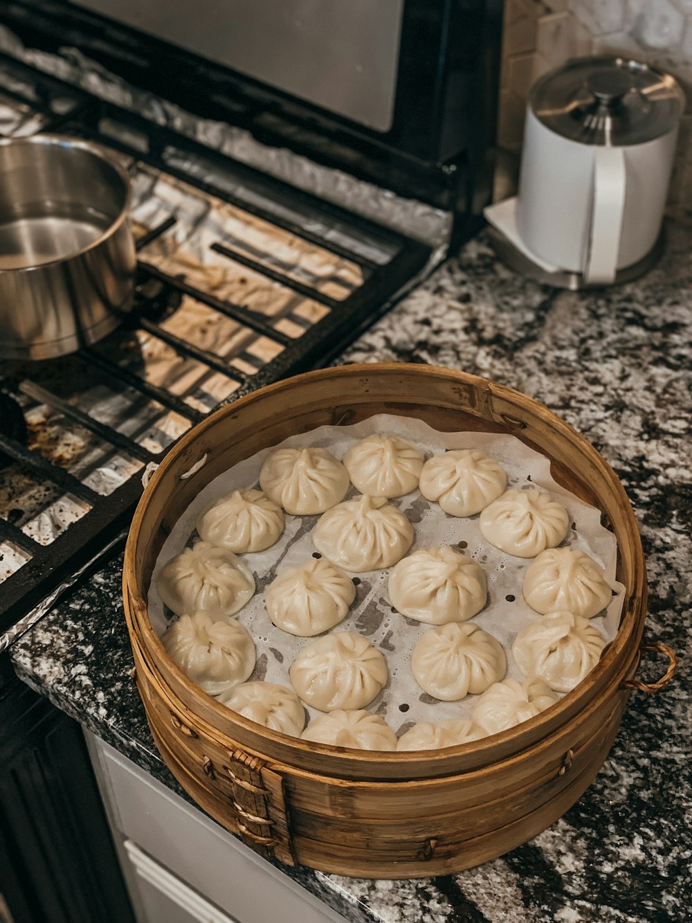 a basket filled with dumplings sitting on top of a counter