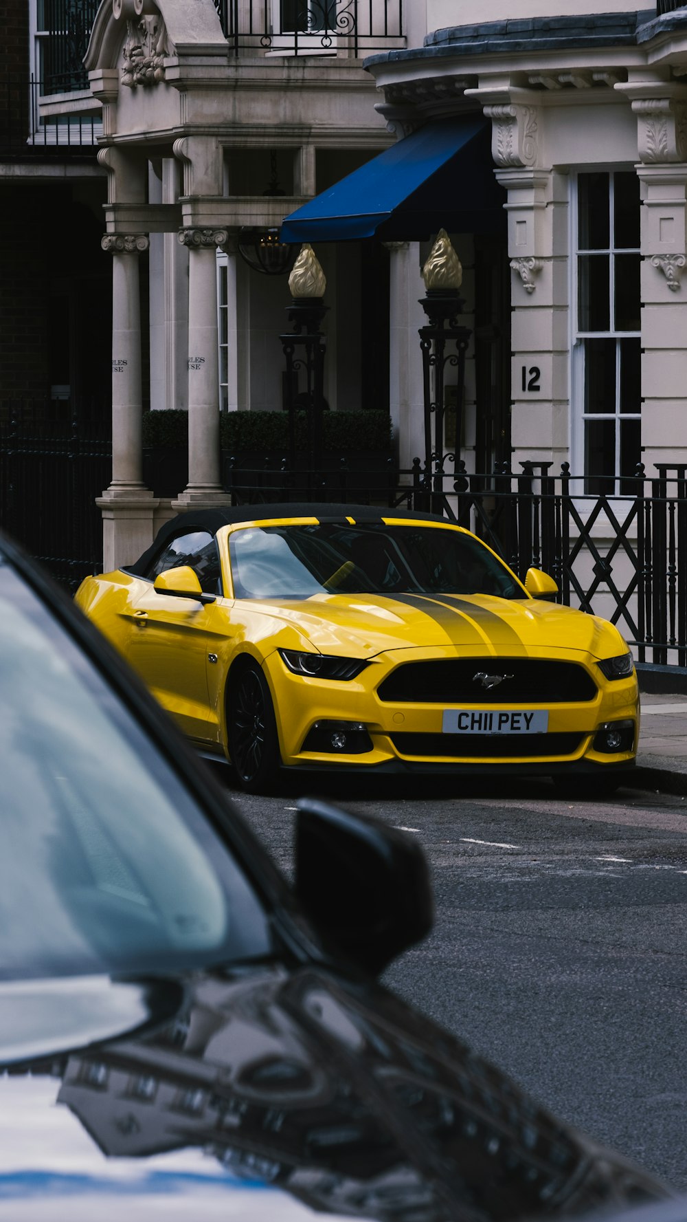 a yellow sports car parked on the side of the road