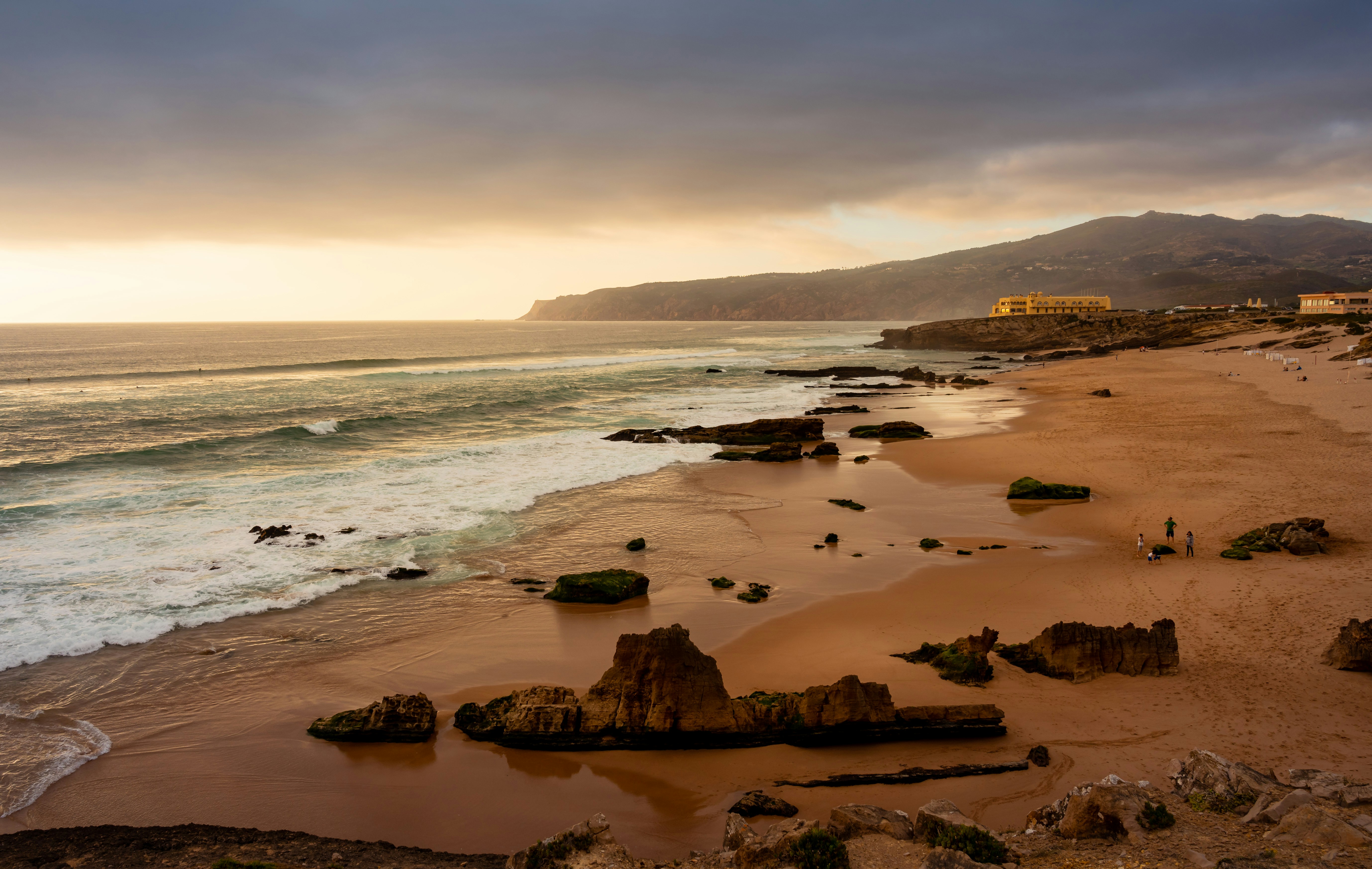 A view of a beach with waves coming in from the ocean, Three attempts to shoot something interesting in Cascais, and nothing good.  Then suddenly snapped this while waiting for my food at a restaurant across the street!  Worth it for the amazing Cataplano, highly recommend.  Oh yeah and I guess the photo turned out okay too.