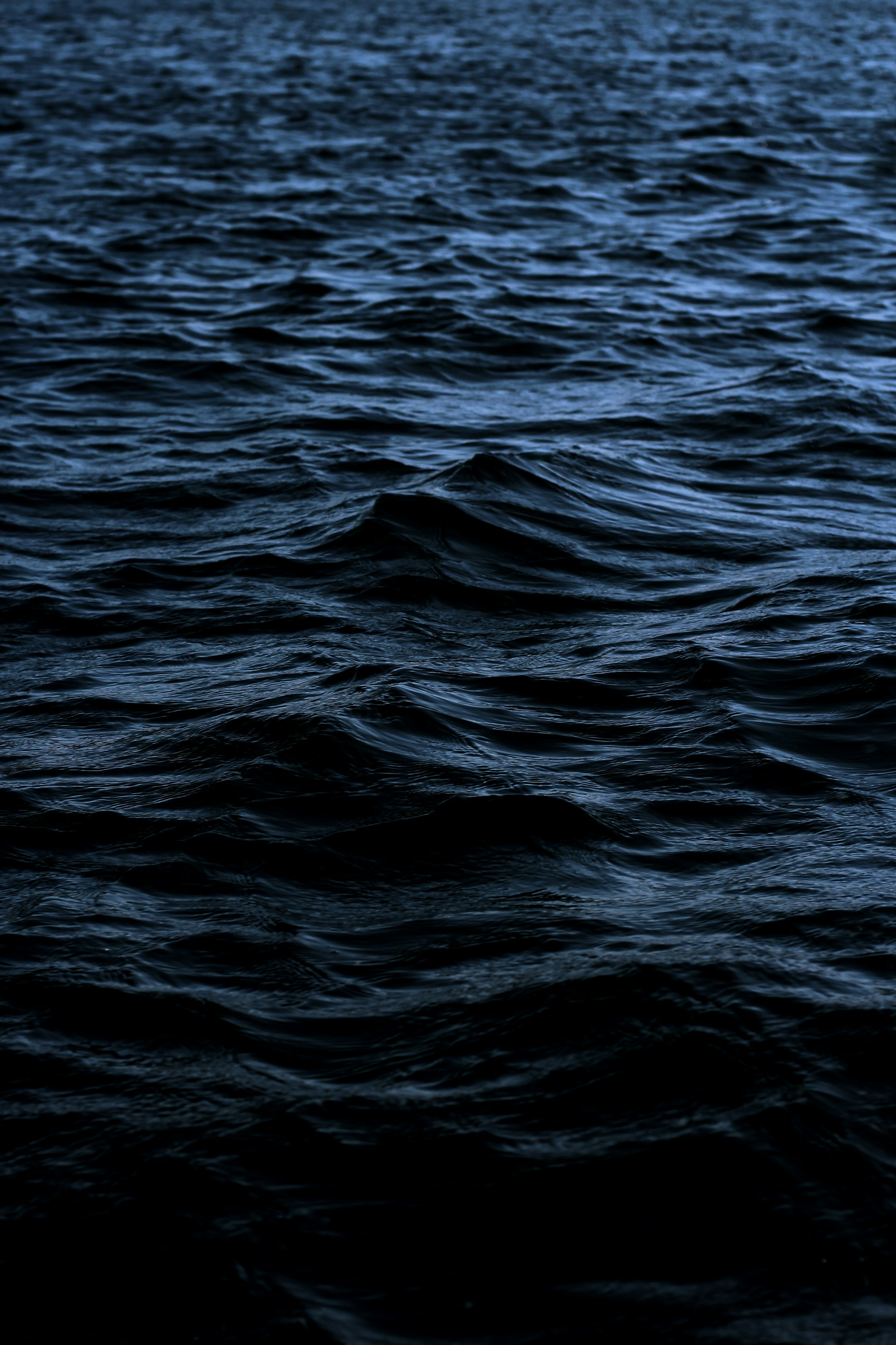 a large body of water with a boat in the distance