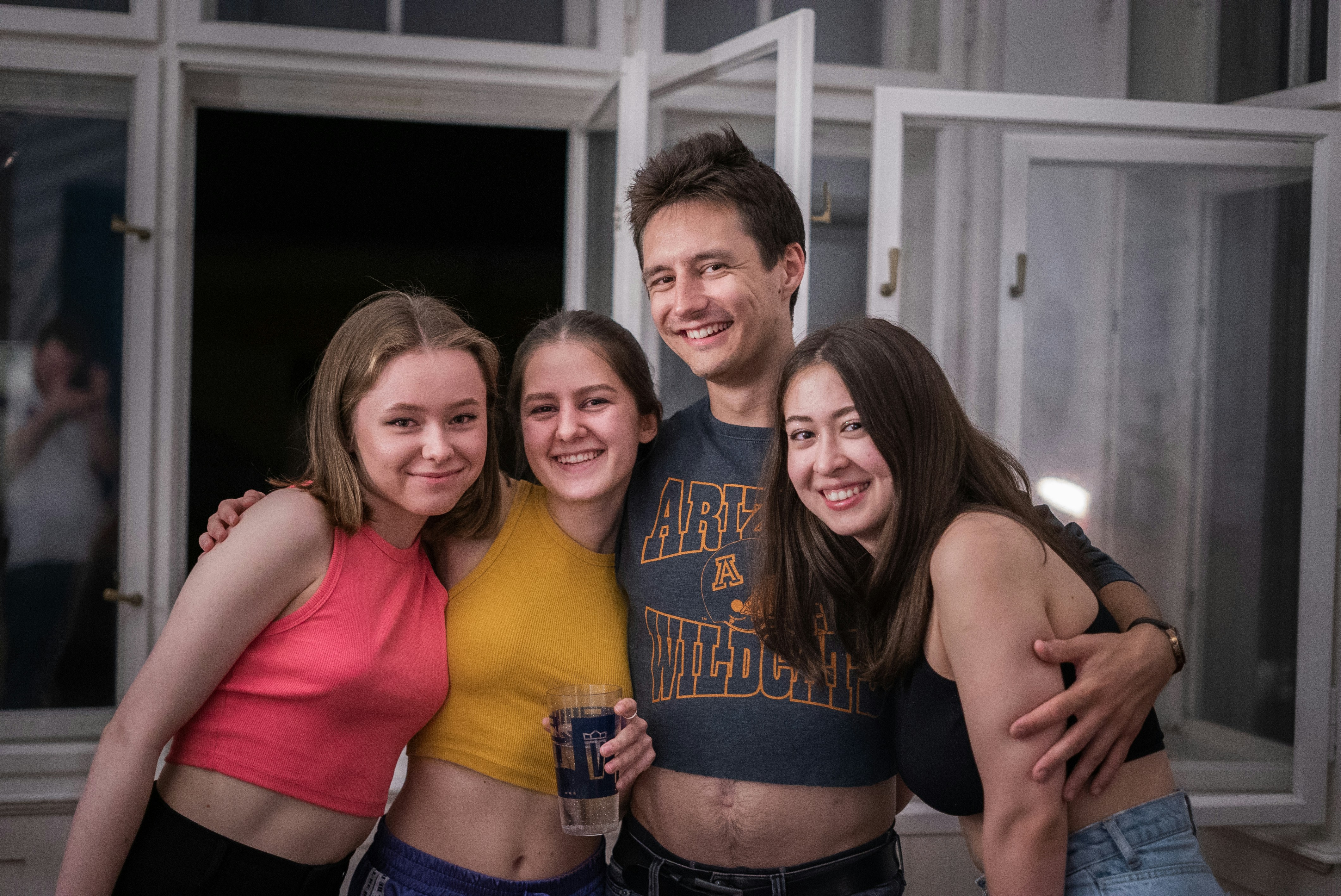 a group of young people standing next to each other, 