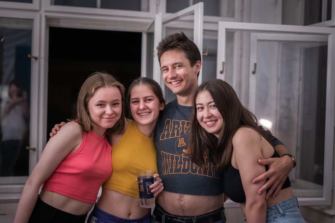 a group of young people standing next to each other,