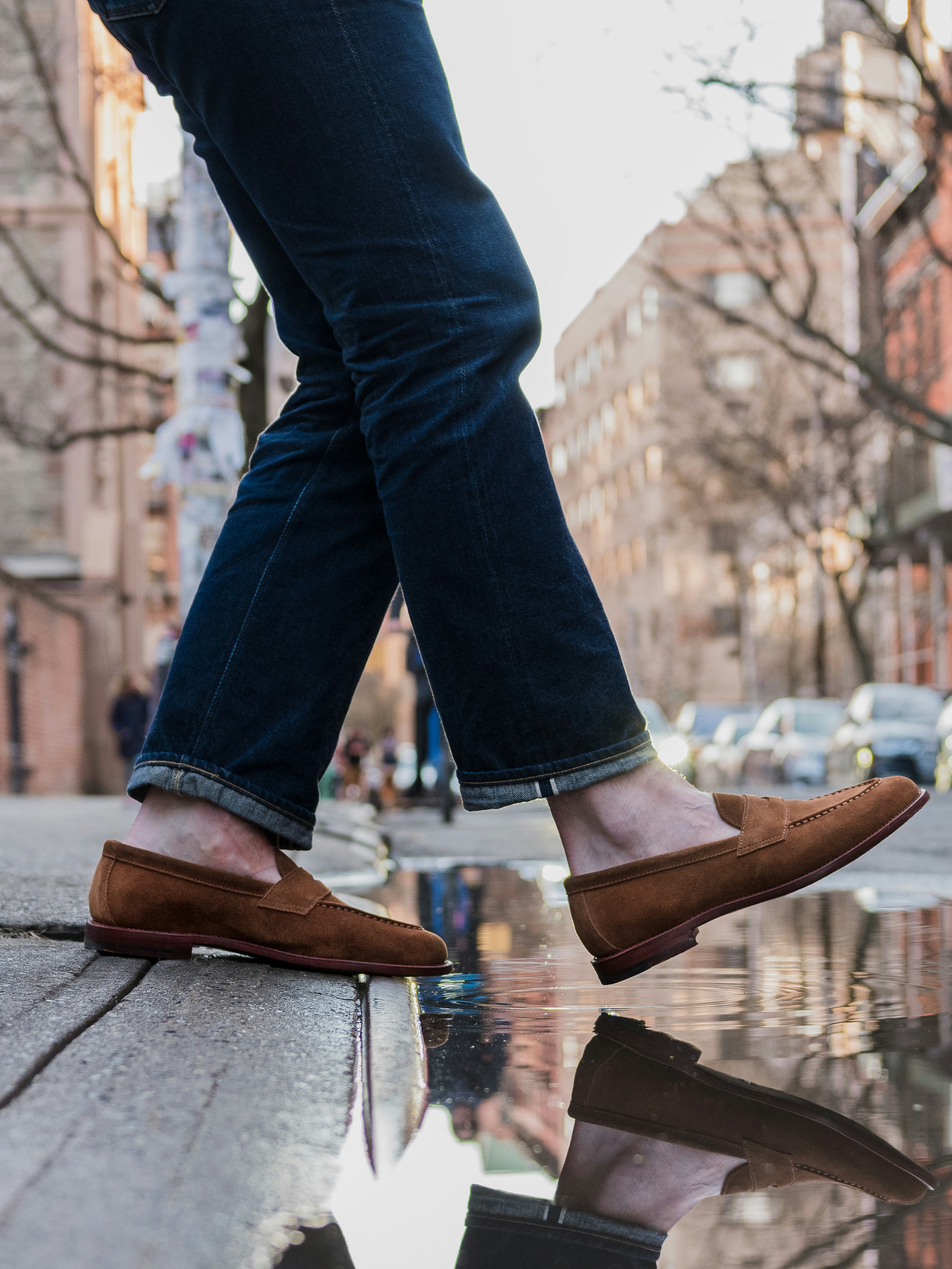 a person's feet are reflected in a puddle