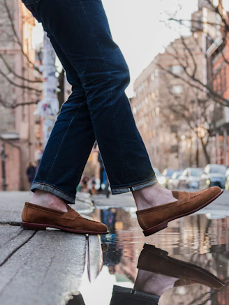 a person's feet are reflected in a puddle