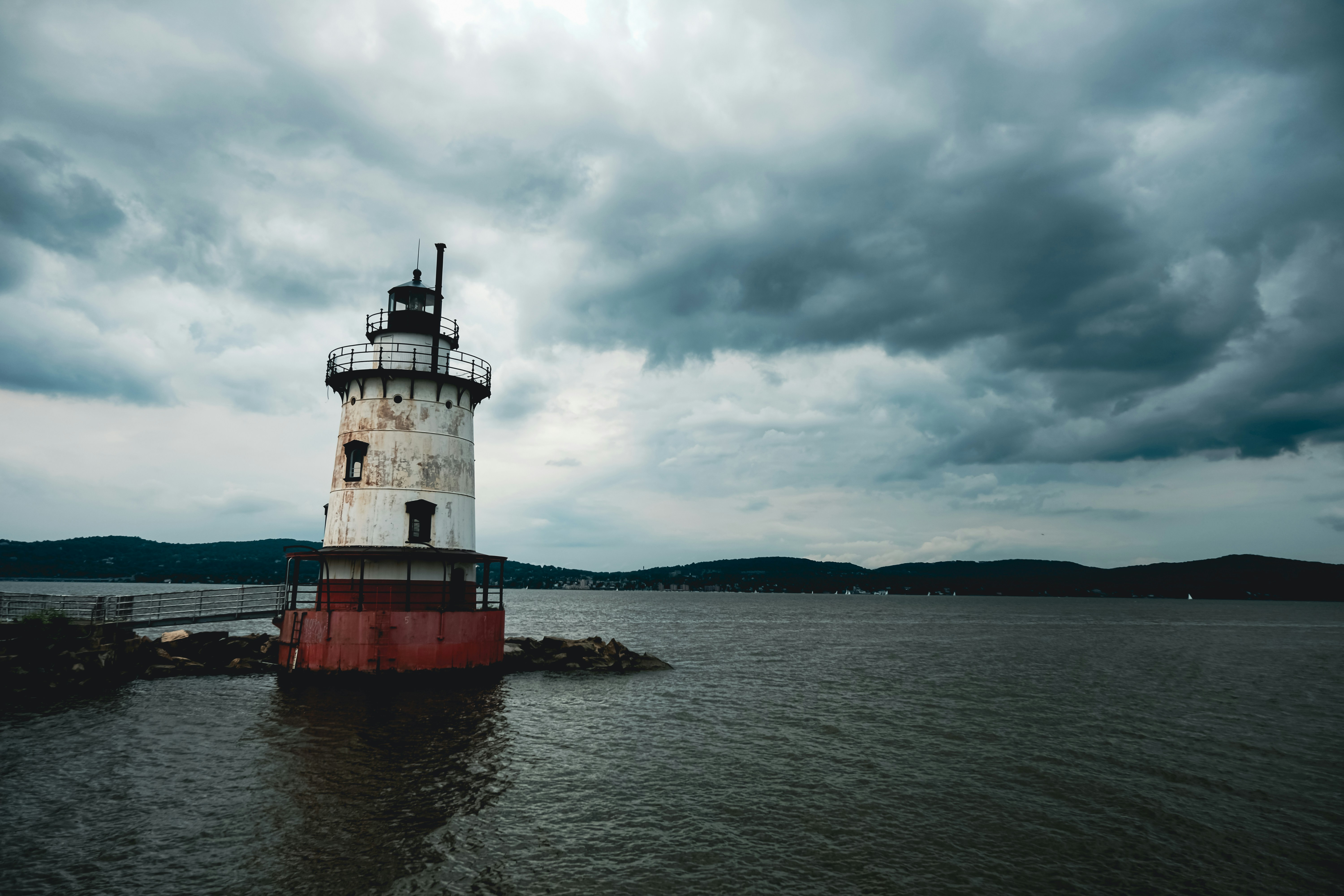a light house sitting in the middle of a body of water