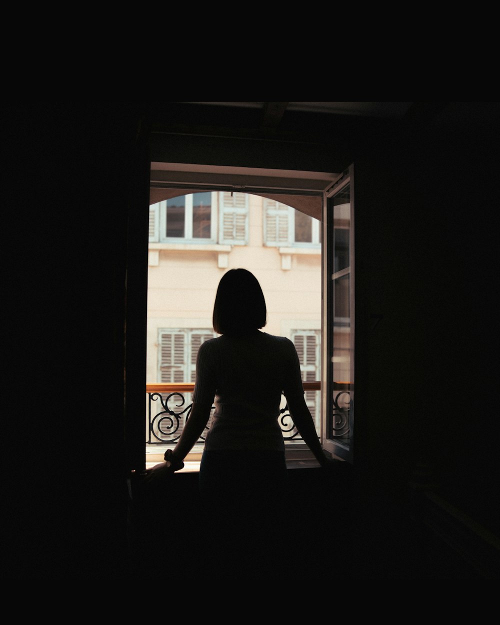 a woman standing in front of an open door