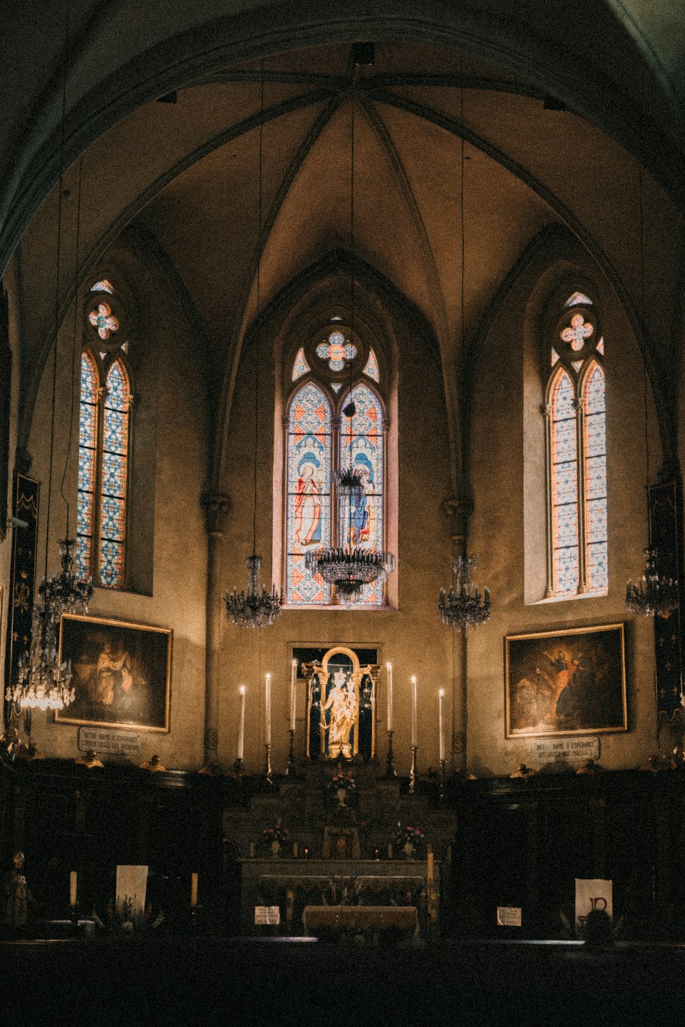 a church with stained glass windows and a chandelier