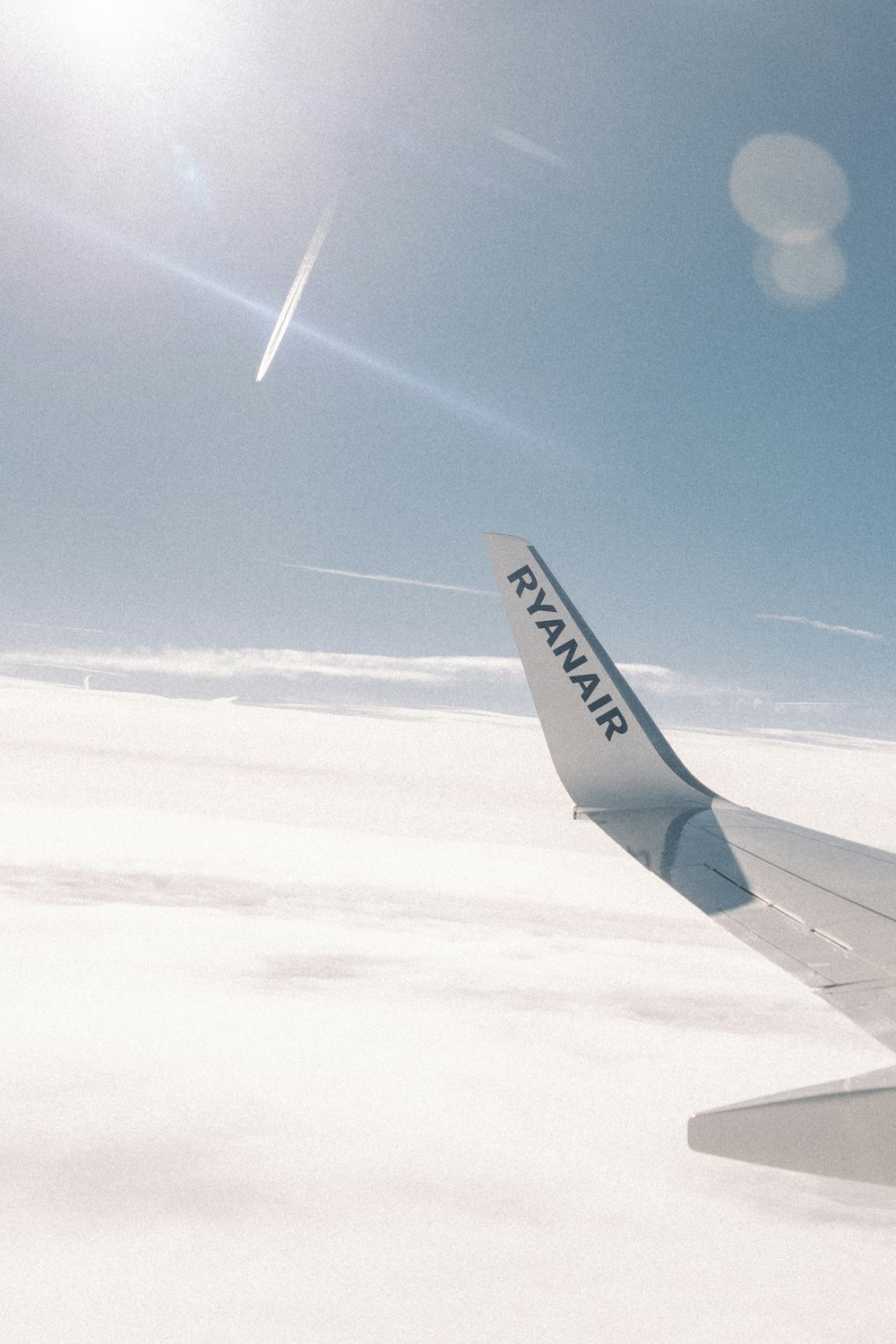 a view of the wing of an airplane in the sky