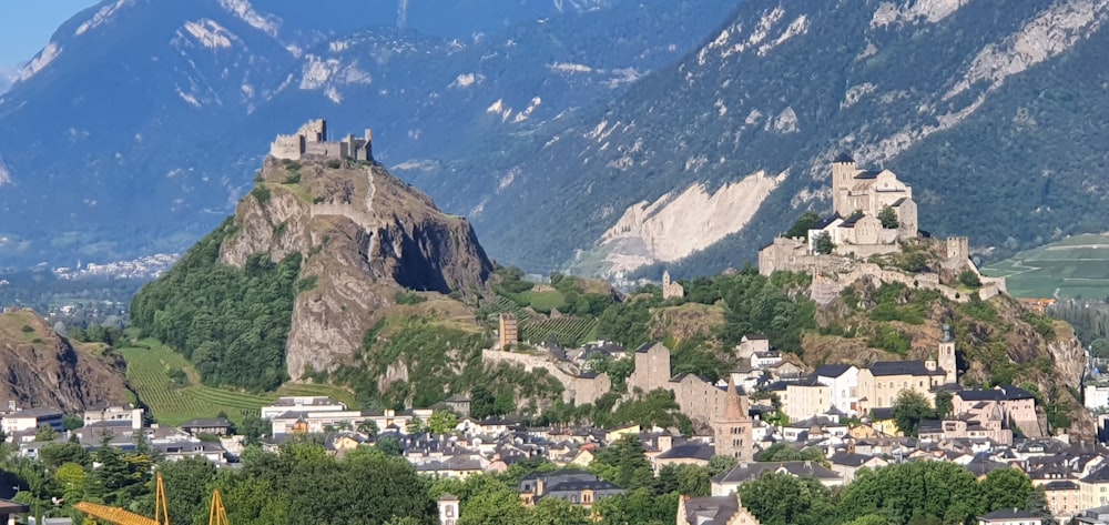 a castle on top of a mountain with a town below