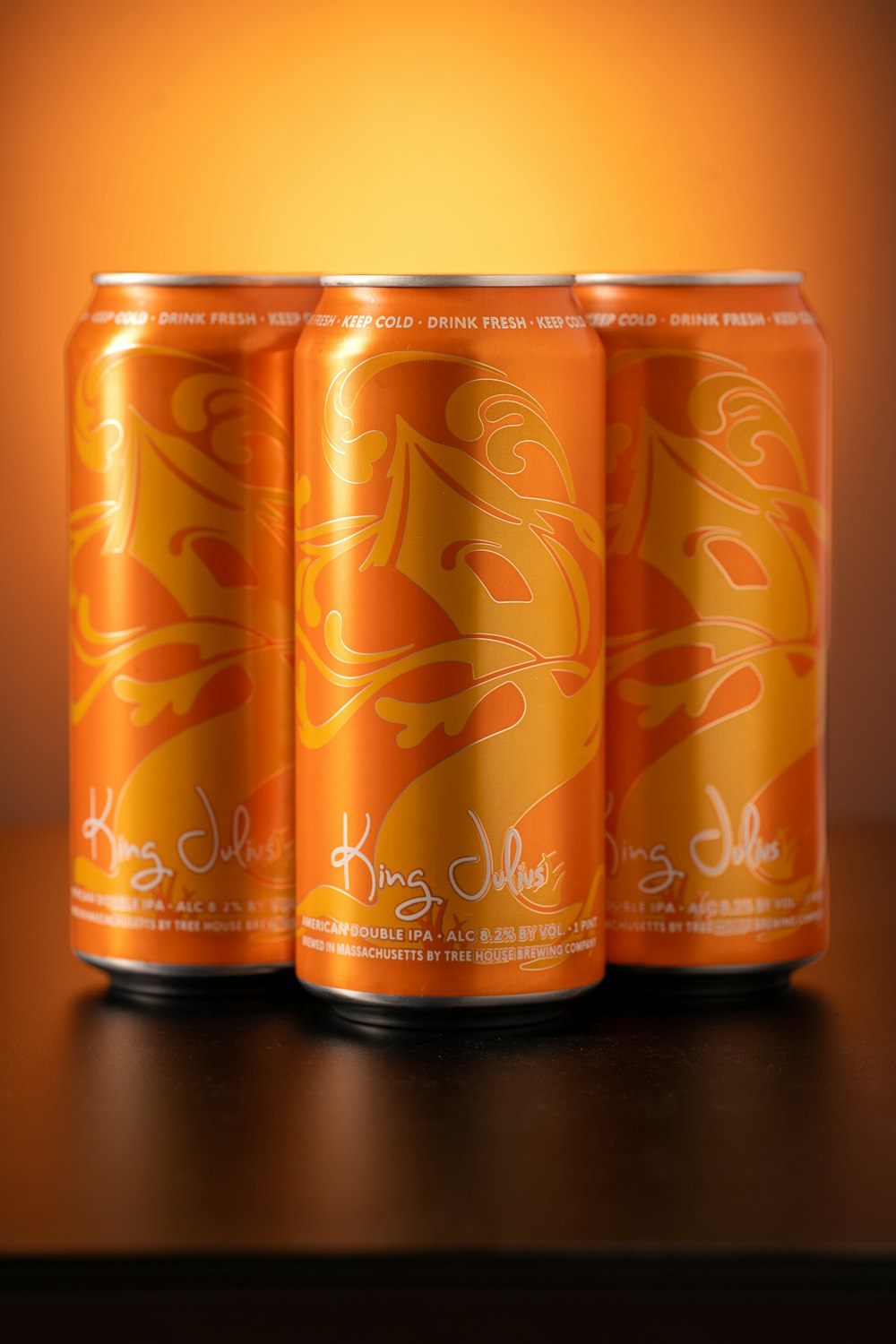 a group of three cans of beer sitting on top of a table