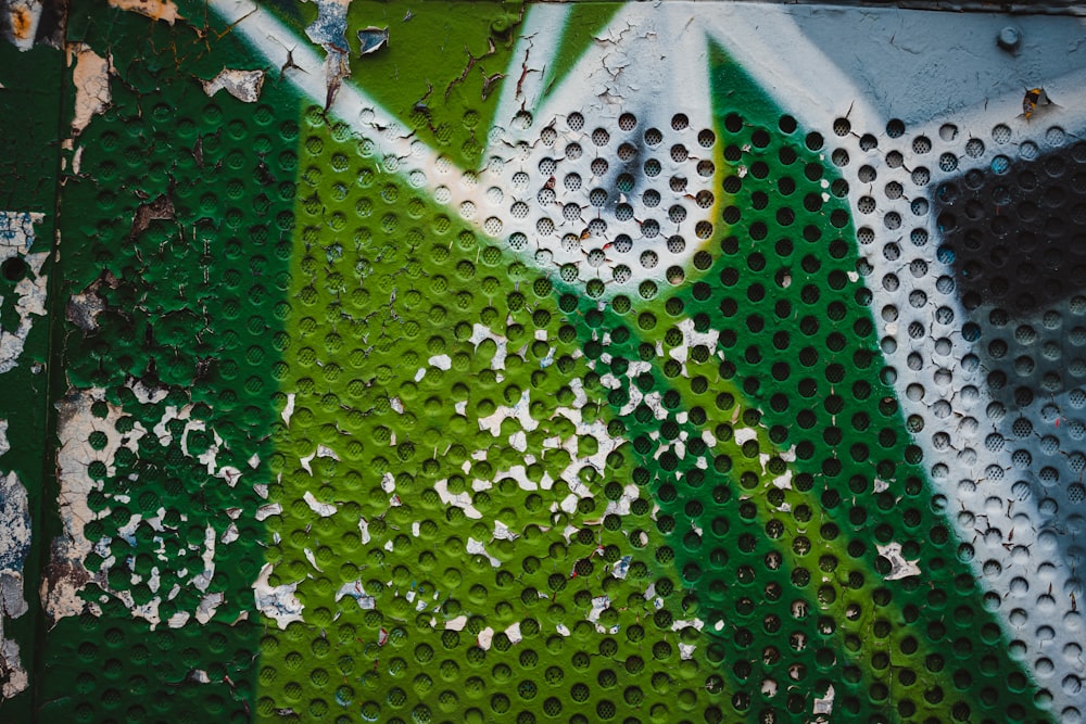 a close up of a green and white wall