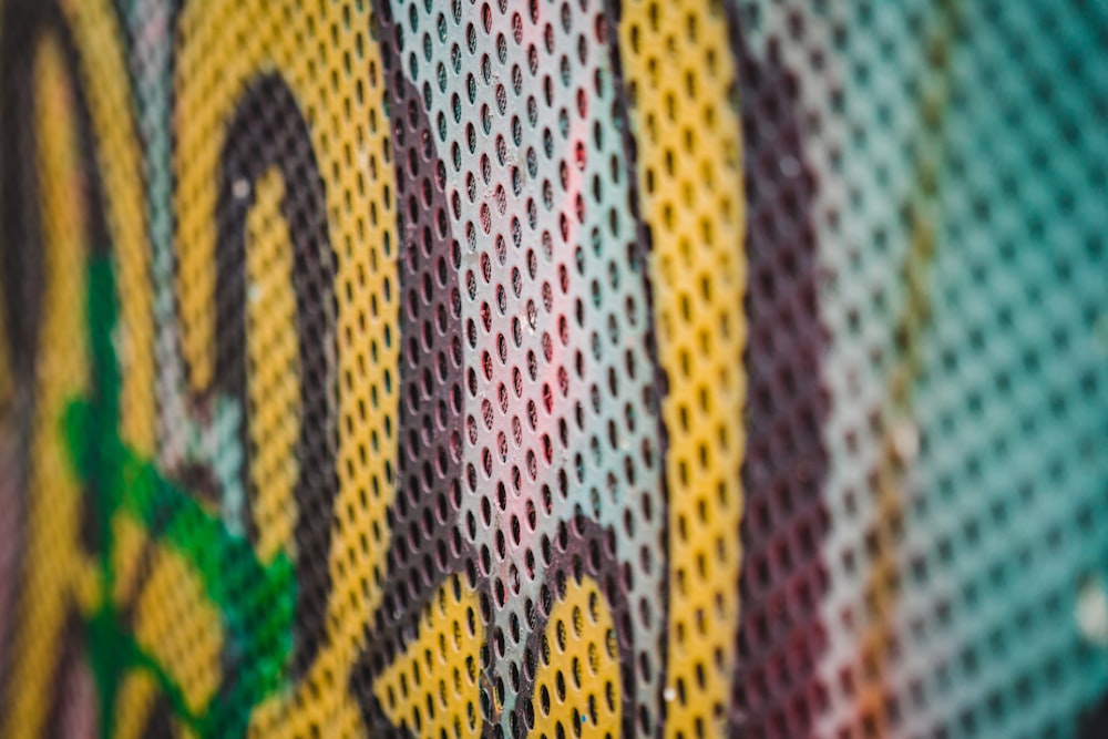 a close up of a wall with graffiti on it