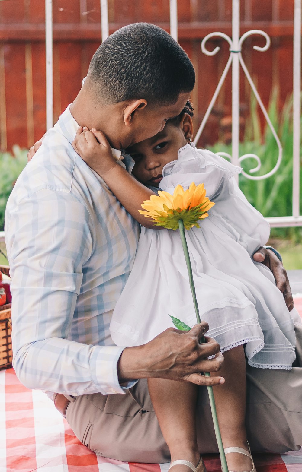 a man holding a little girl on his lap