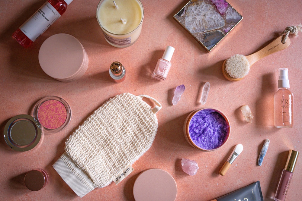 a table topped with lots of different types of cosmetics