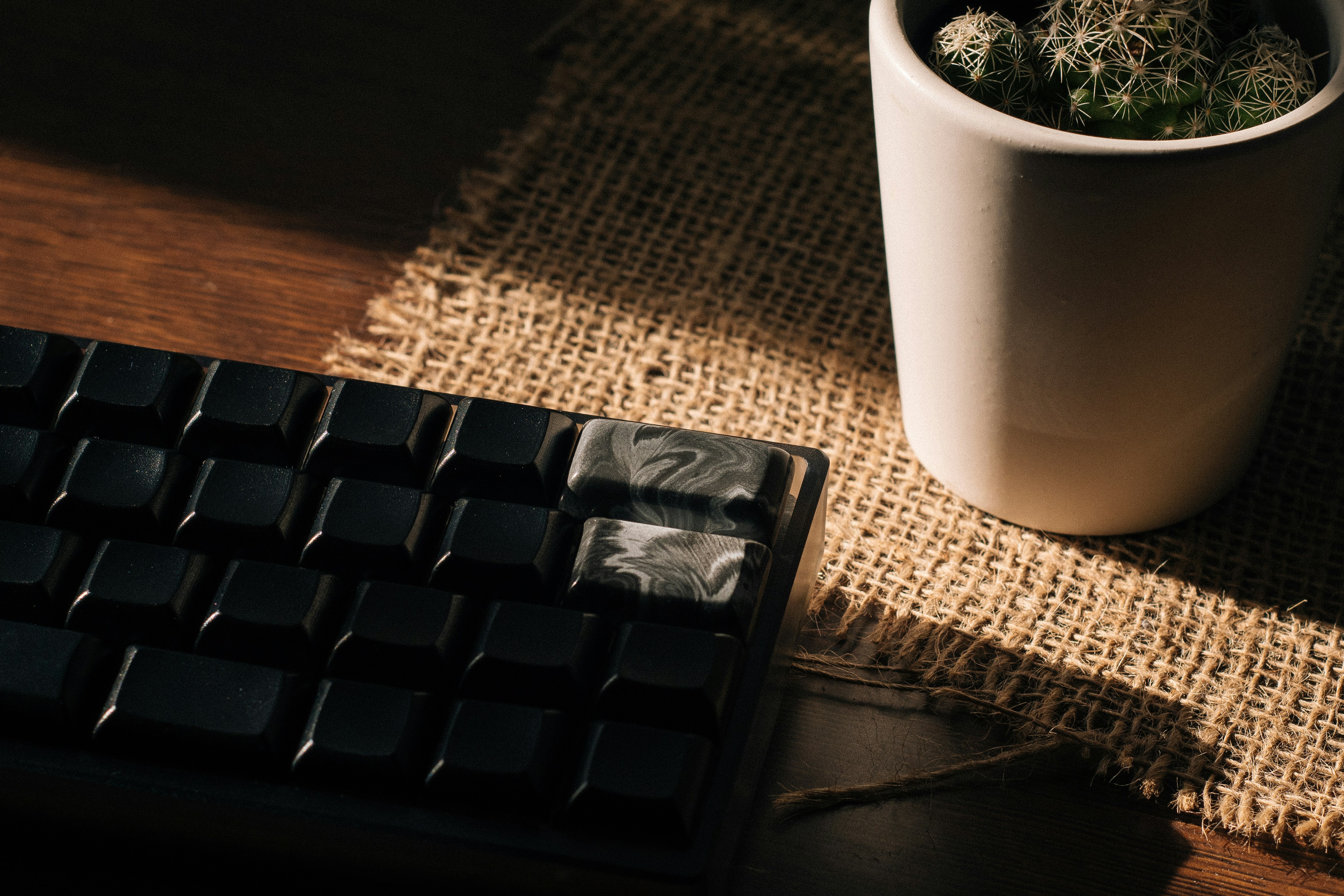 a coffee cup sitting next to a computer keyboard