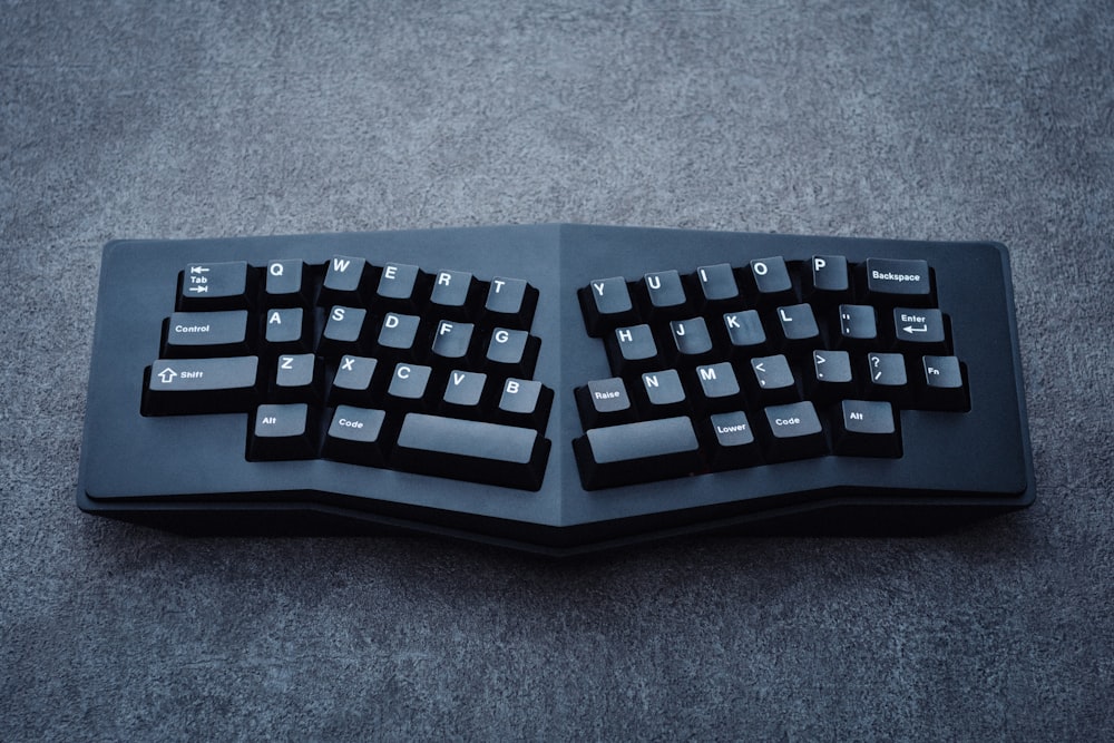 a computer keyboard sitting on top of a table