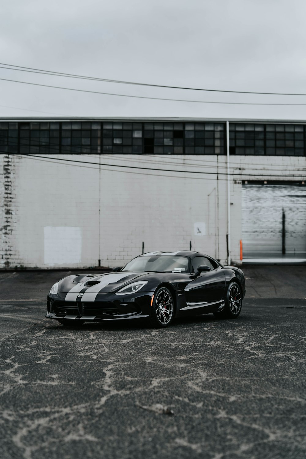 a black sports car parked in a parking lot