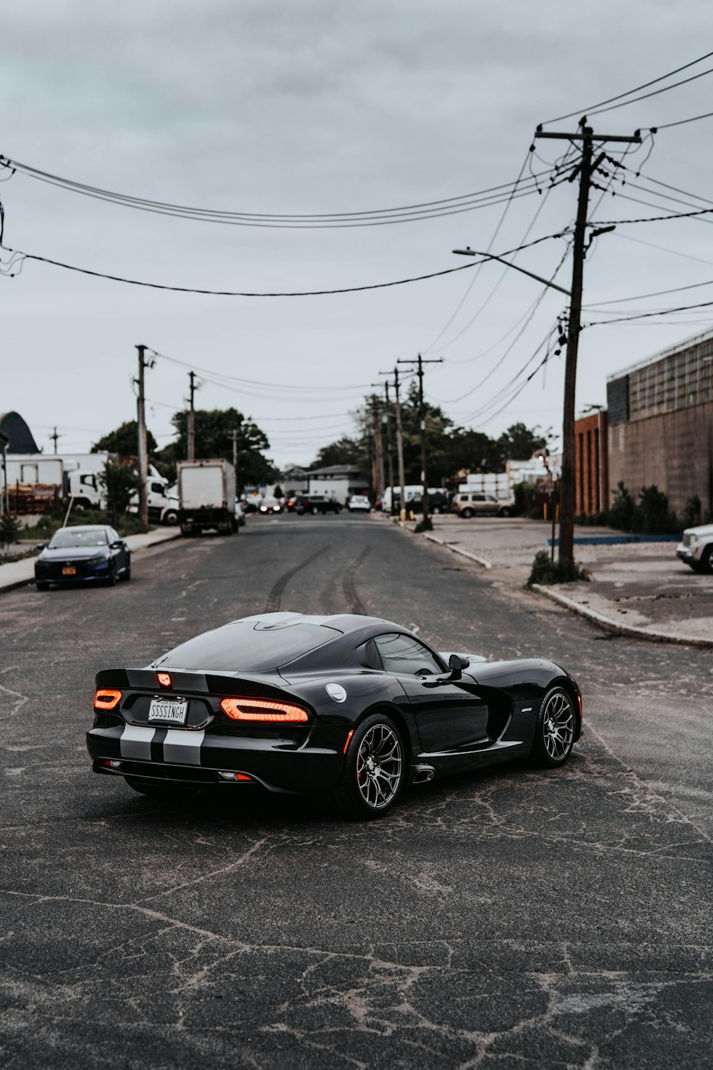 a black sports car parked in a parking lot