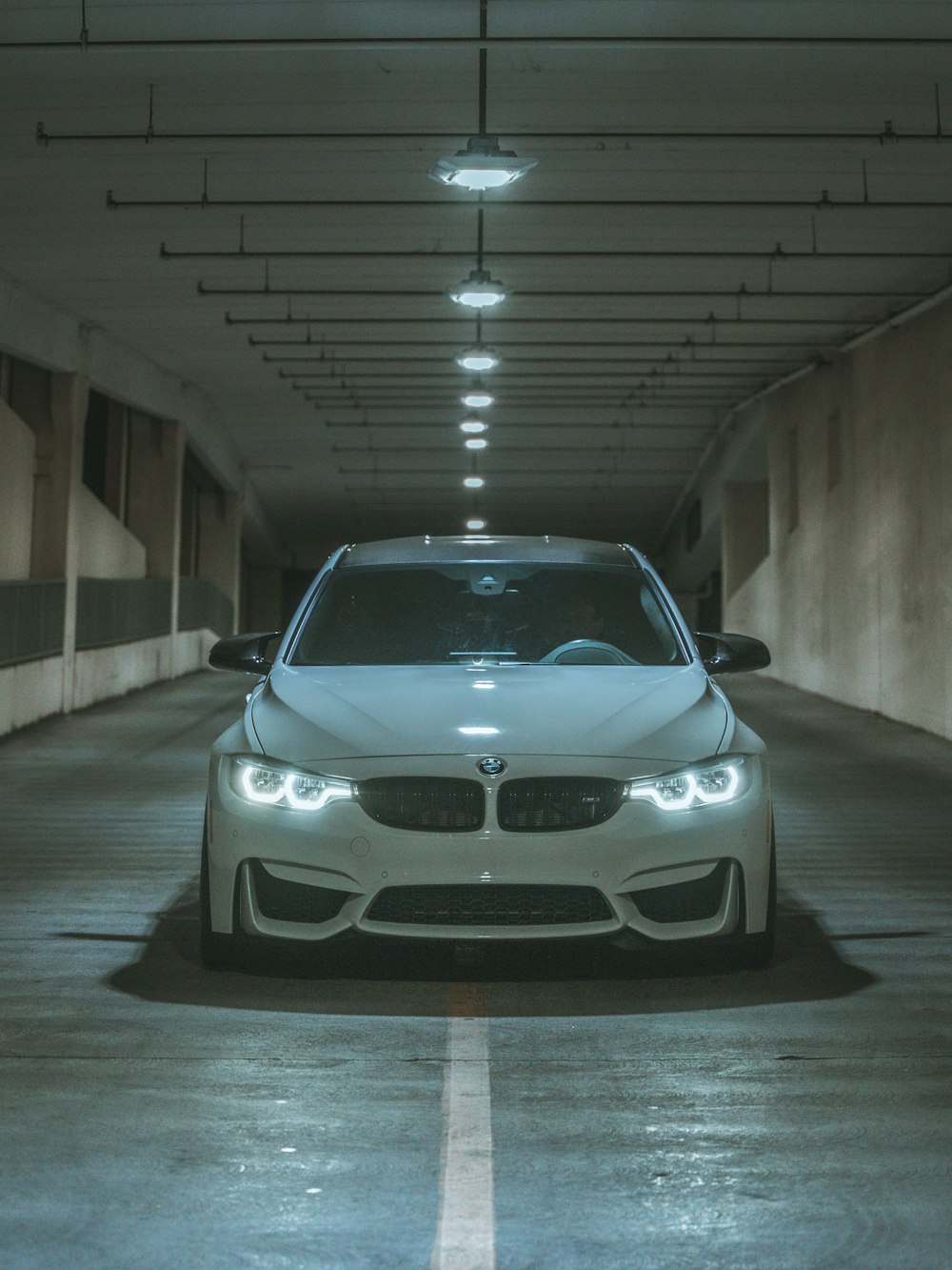 a white car parked in a parking garage