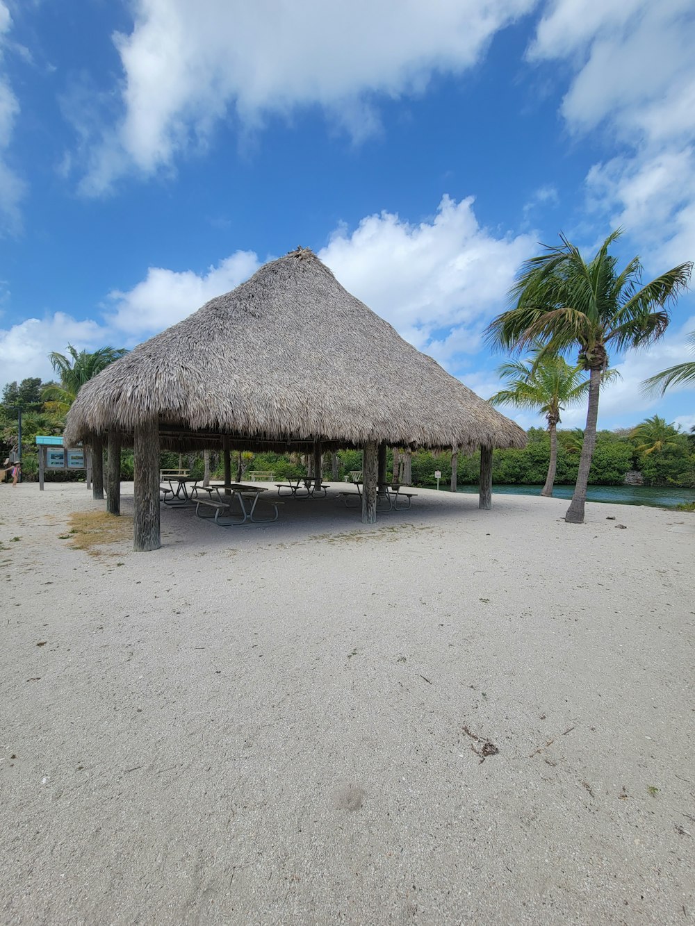 a hut with a thatched roof on a beach