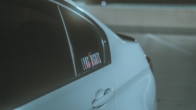 Close-up of a sleek digital parking tag displayed on a car windshield.