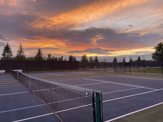A sleek modern tennis court under sunset light, symbolizing focus and performance.