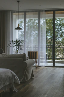 Sunlit living room with plush sofa and tropical plants at Tiara Haven.