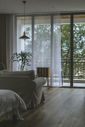 Cozy living room with bright tropical decor and large windows in a Cartagena apartment.