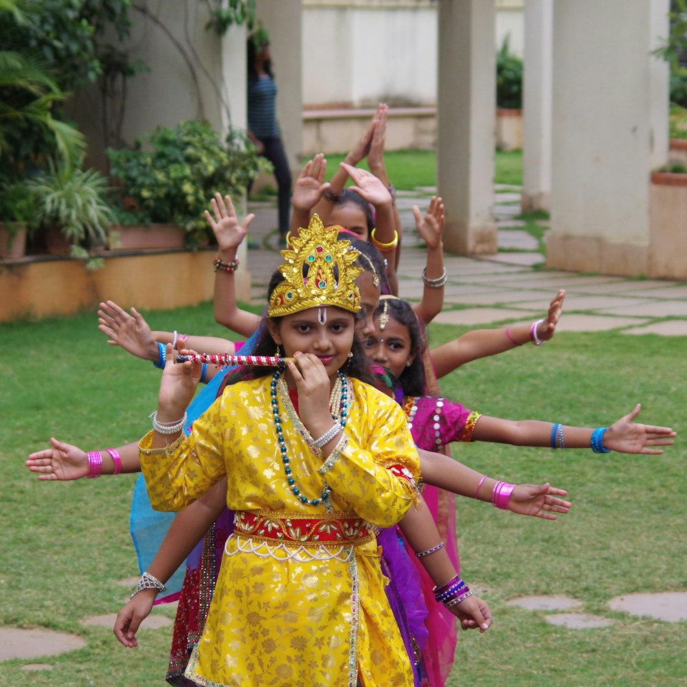 a group of young girls dressed in traditional indian garb