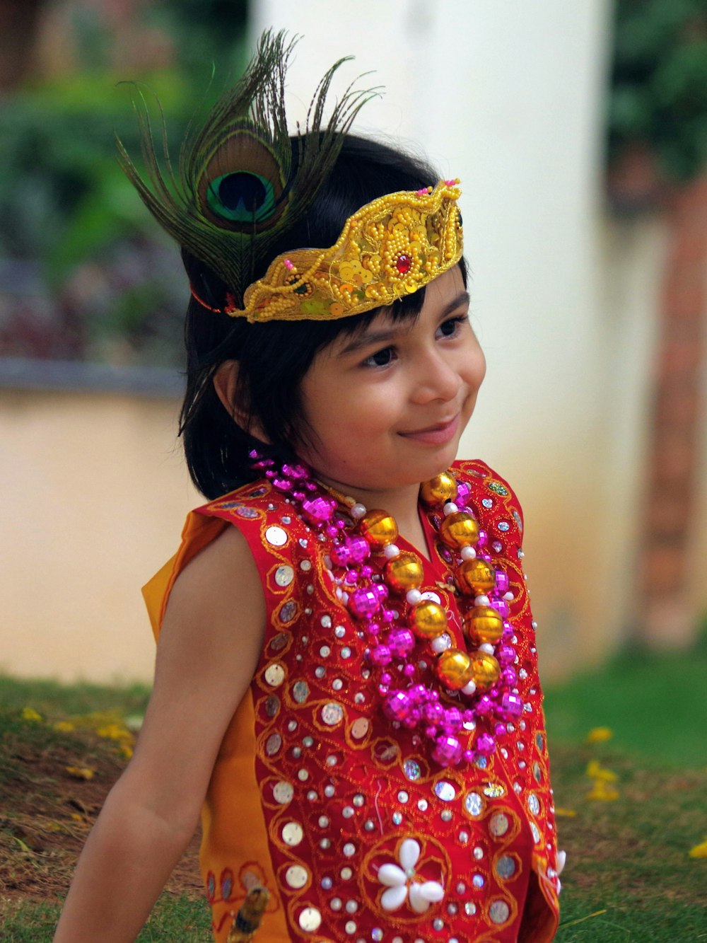 a little girl wearing a colorful head piece
