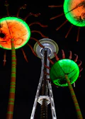 A towering, colorful sculpture glowing under the desert sunset.