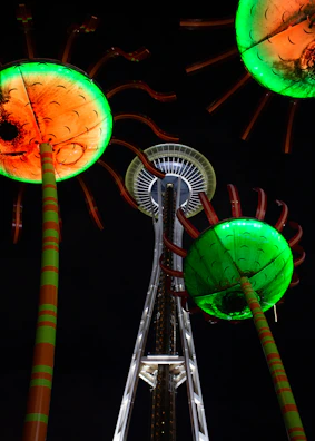 A towering, colorful sculpture glowing under the desert sunset.