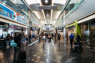 a group of people walking through an airport