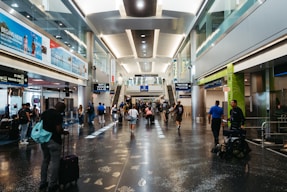 a group of people walking through an airport