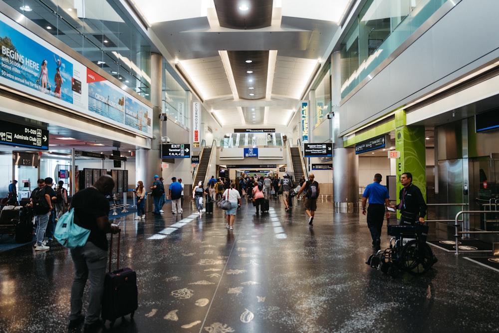 a group of people walking through an airport