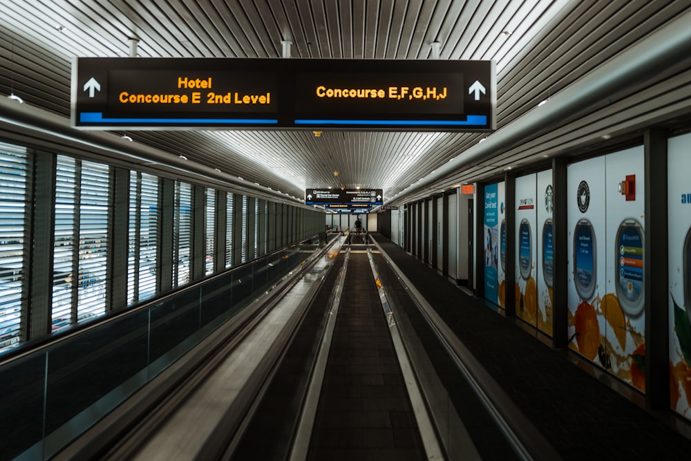 an empty subway station with a sign above it