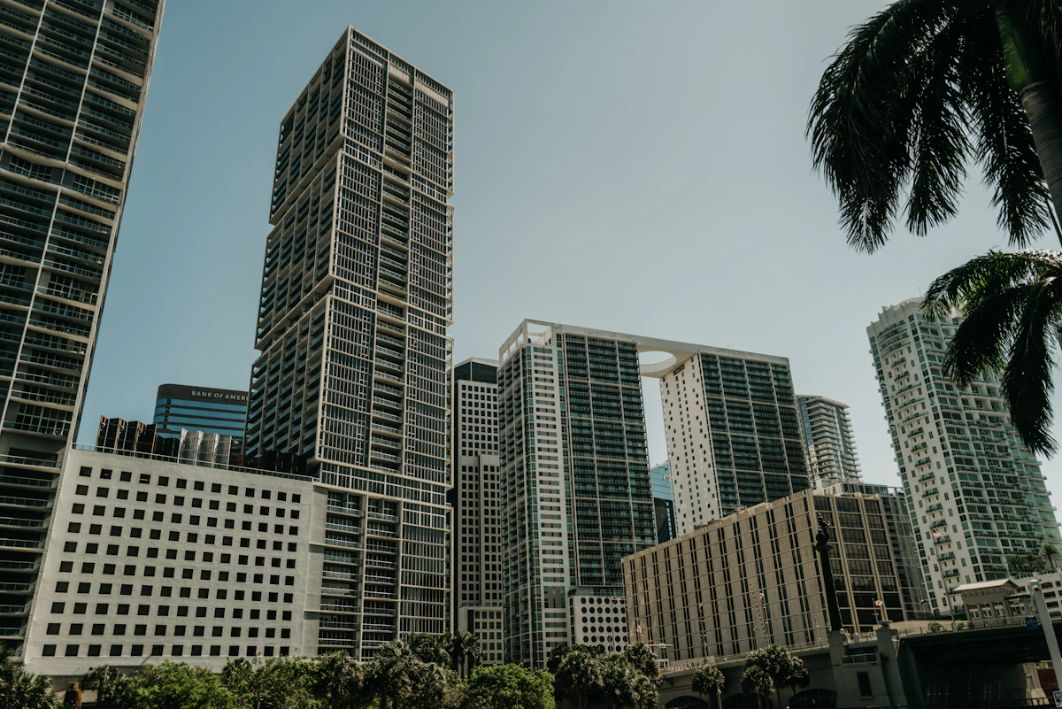 Brickell high-rises framed by palm trees under a sunny Miami sky