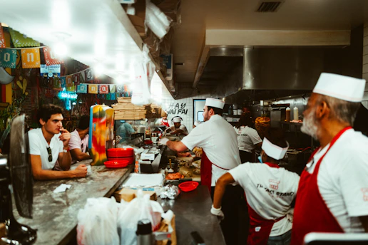 A busy restaurant counter with staff efficiently preparing orders.