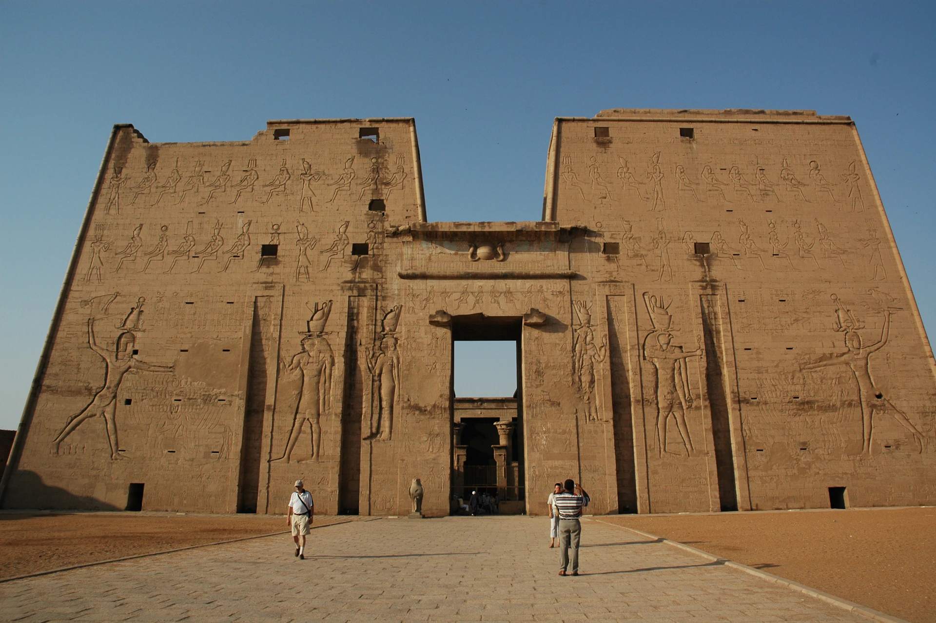 two people standing in front of a large building