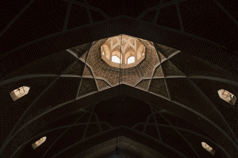 the ceiling of a large building with many windows