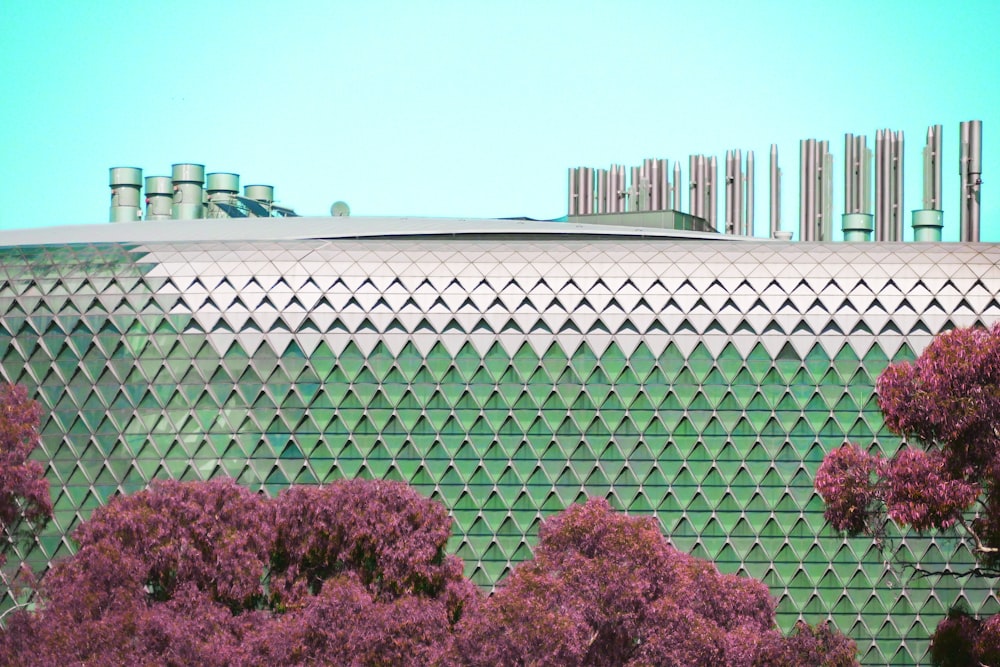 a building that has a lot of trees in front of it