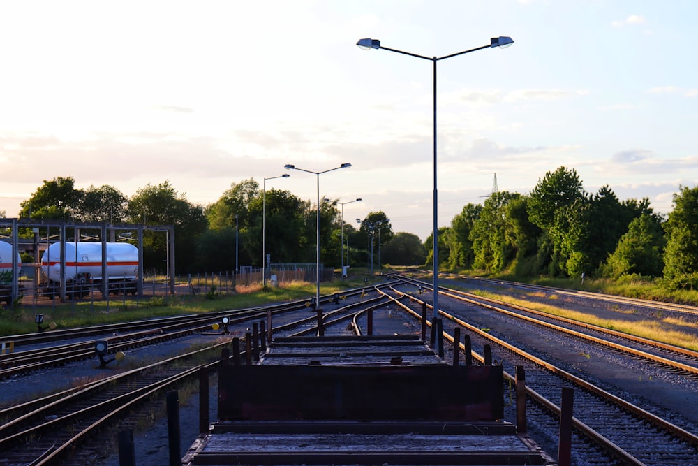 a set of train tracks next to a train yard