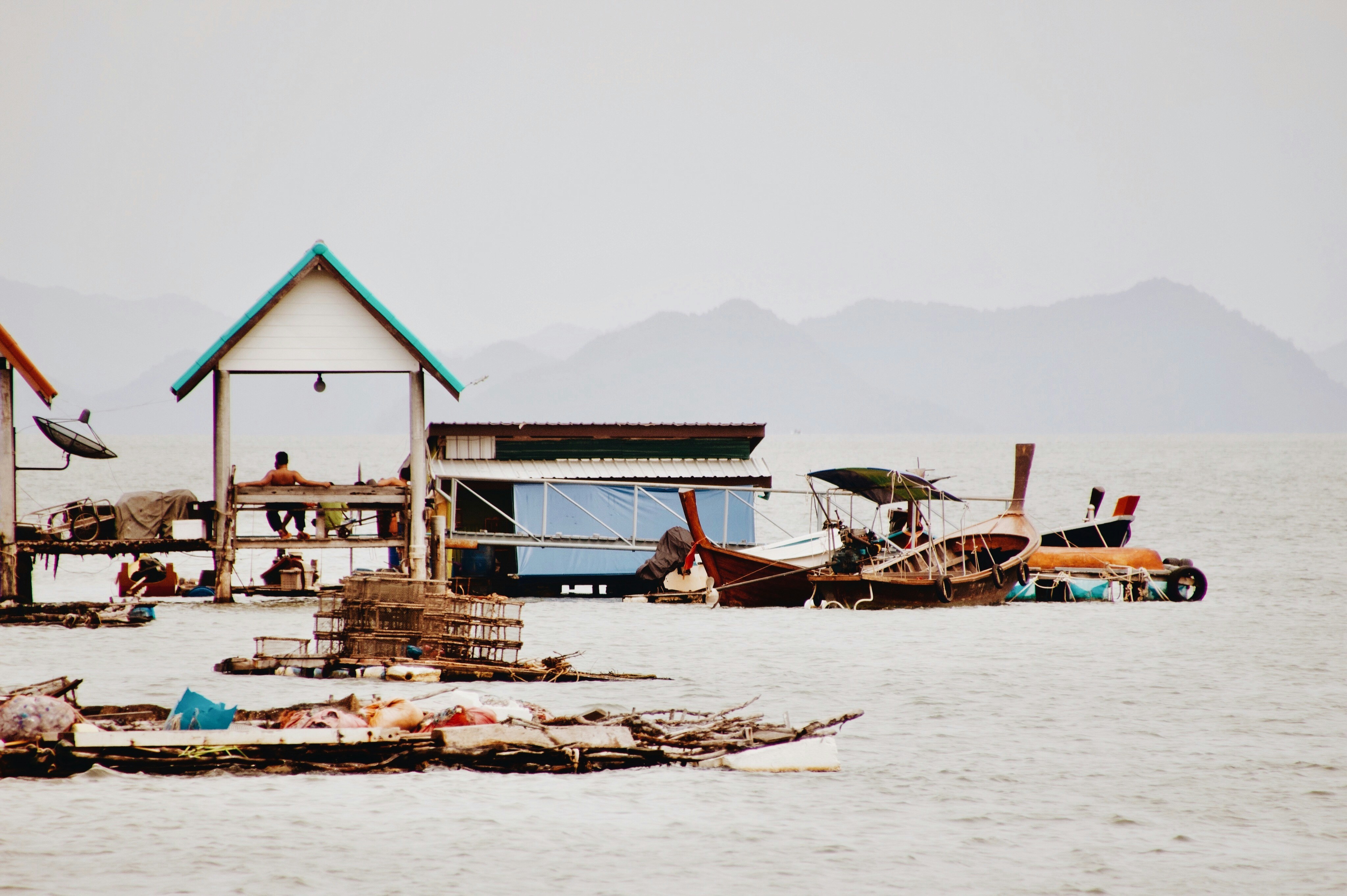 a group of boats floating on top of a body of water